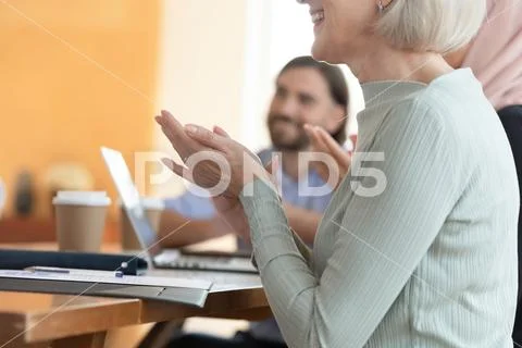 Close up smiling middle aged business woman clapping hands. Stock Photos