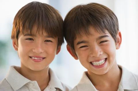 Close up of smiling mixed race twin brothers Stock Photos