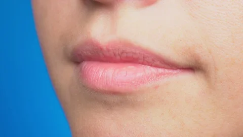 Close-up of smiling teeth, isolated on blue background. 4k. Slow motion Stock-Footage 93905061