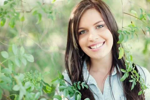 Close up of smiling woman standing in garden Stock Photos