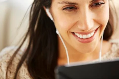 Close up smiling woman using digital tablet with headphones Stock Photos
