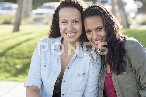 Close Up Of Smiling Women Hugging In Park