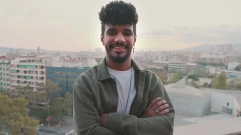 Close-up of smiling young guy with arms crossed posing at camera while standing Stock Footage 252030872