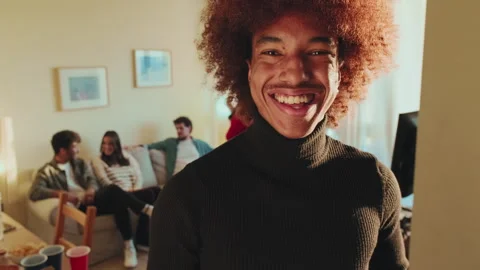 Close-up of smiling young man looking at camera in living room Stock Footage 255505033