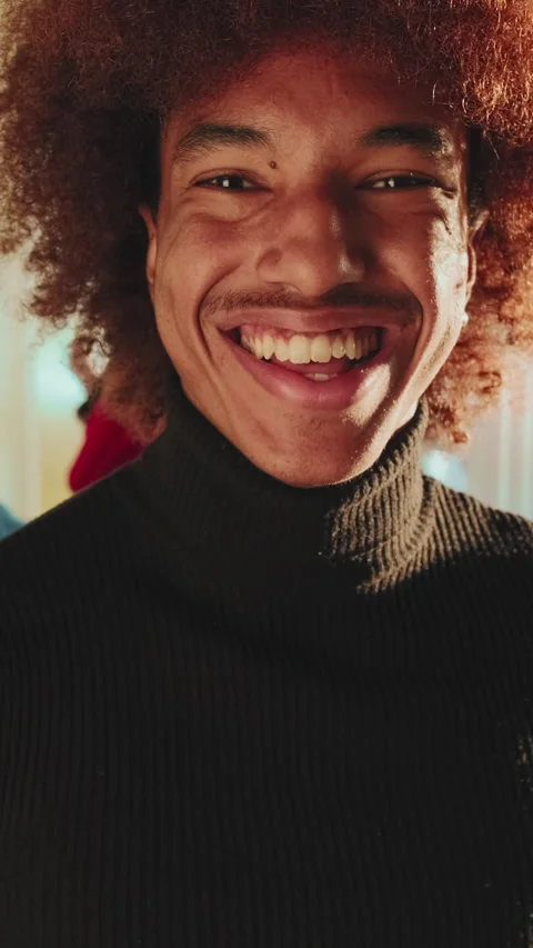 Close-up of smiling young man looking at camera in living room Stock Footage 255505039