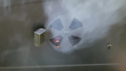 Close-Up of Smoke Escaping from BBQ Grill Air Vent with Glowing Embers 스톡 동영상 336856371