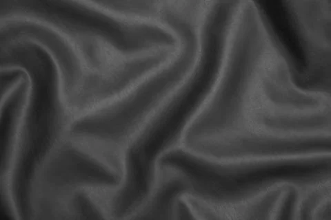 Close-up of smooth black leather texture highlighting soft folds and natural  Foto stock
