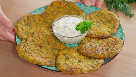 Close-up, smooth camera movement of a dish with zucchini pancakes and sauce Stock Footage 270150301
