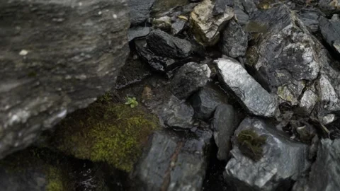 Close up of a smooth flowing water over rocks in the Mountains. Stock Footage 144687800