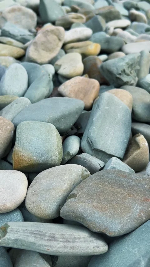 Close up of smooth river stones and pebbles.  Video stock 333632581