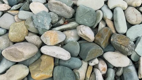 Close up of smooth river stones and pebbles.  Vídeo Stock 333632750