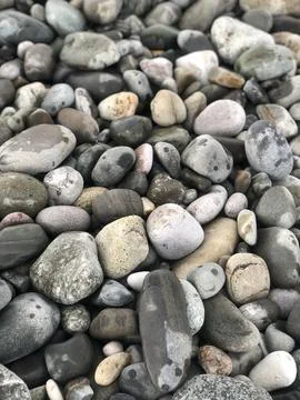 Close-up of smooth, water-worn pebbles and rocks. Stock Photos
