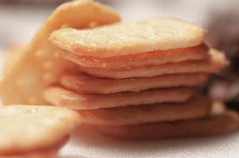 Close-up of a snack with cheese. A stack of dry cookies. Stock Photos
