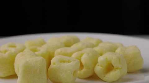 Close up snack food crispy Corn rings chips salty rotates slowly. Fast food or j Stock Footage 152807897