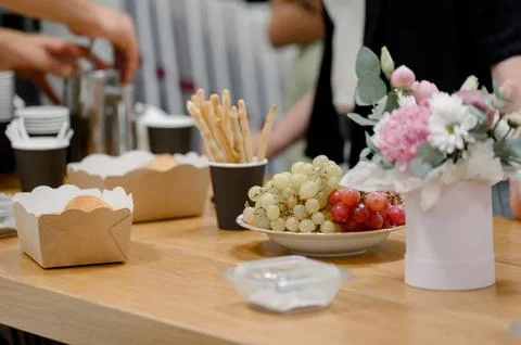 Close-up of a snack setting with red and green grapes in a business setting. Stock Photos