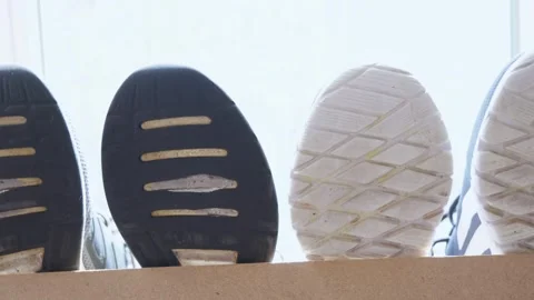 Close-up of sneaker soles drying in the sun Stock Footage 306573312
