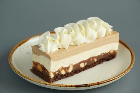 Close Up of Snickers Layered Cake Slice with Caramel, Nougat and Nuts Stock Photos