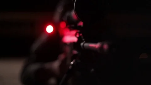 Close up of sniper looking through scope at night  Stock Footage