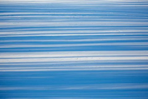 Close-up of snow and shadow patterns caused by trees Stock Photos
