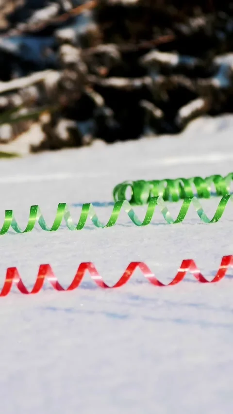 Close-up. on the snow are multi-colored tinsel and confetti. Christmas Stock Footage 323007904
