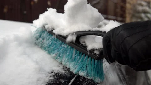 A close-up of a snow brush clears off snow. Winter in Russia, the car was Stock-Footage 145770332