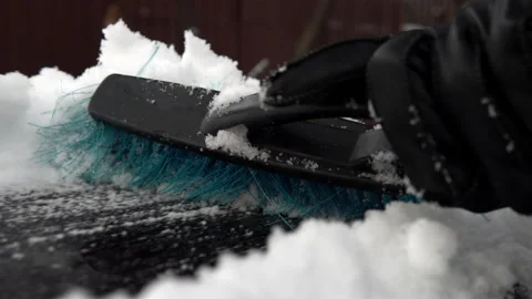 A close-up of a snow brush clears off snow. Winter in Russia, the car was Stock Footage 145770551