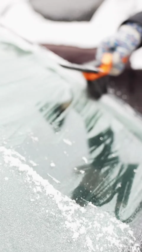 Close-up of a snow brush ice scraper clearing frost from a car windshield Stock-Footage 328355044