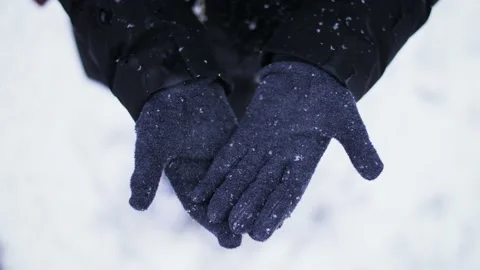 Close up of snow falling slowly on woman's glove in nature during winter. Stock Footage 147158789