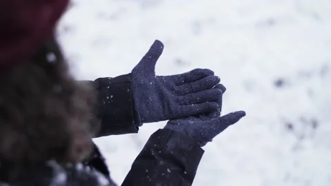 Close up of snow falling slowly on woman's glove in nature during winter. Stock Footage 147158814