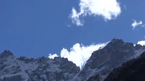 Close up of snow mountain summit and fast moving clouds Stock Footage 43222370