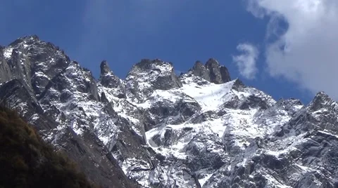 Close up of snow mountain summit and fast moving clouds Stock Footage 43222423