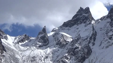 Close up of snow mountain summit and fast moving clouds Stock Footage 43222474