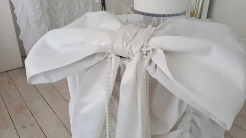 Close-up of snow-white wedding decorations- a large white bow made of fabric Stock Footage 303925055