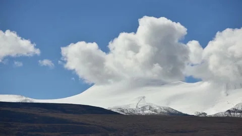 Close up snowcapped mountain and clouds in timelapse Stock Footage 142861353