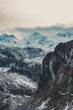 Close up of the snowed mountain range during winter with clouds Stock Photos