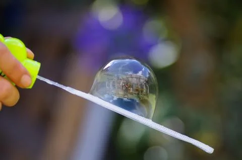 Close up of a soap buble on a blurred background, with a building reflection in 스톡 사진