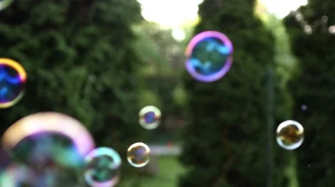 Close up of soap colorful bubbles floating in the air Video stock 53483995