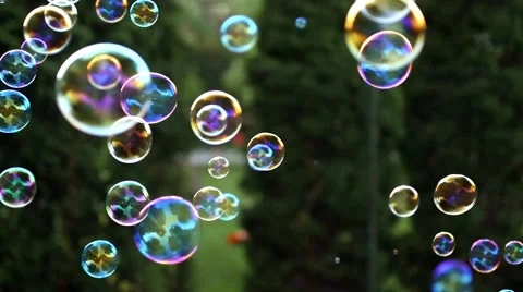 Close up of soap colorful bubbles floating in the air. Stock Footage