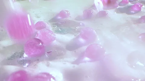Close-up soap foam texture with pink gel balls, white shampoo soapsud background Vídeo Stock 308513340