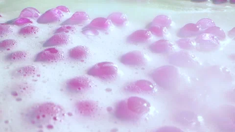 Close-up soap foam texture with pink gel balls, white shampoo soapsud background Stock Footage 311511380