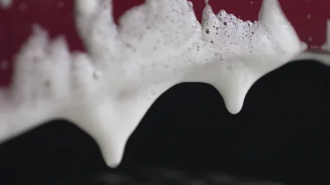 Close up of soapy foam drop dripping from car body during wash 動画素材 310177529