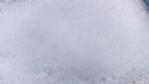 A close-up of a soapy foam that is moving. Waves and rotation create movement in Video stock 146720394