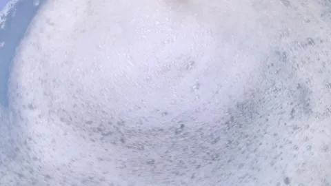 A close-up of a soapy foam that is moving. Waves and rotation create movement in Stock Footage 146720407
