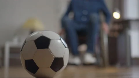 Close-up soccer ball with disabled blurred man rolling wheelchair from 스톡 동영상 164933724