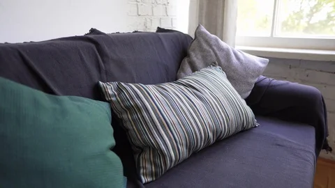 Close-up of a sofa by the window, a cozy interior in natural materials in design Stock Footage 114565898
