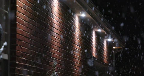 Close up soffit lights on house during snow storm at night Vídeo Stock 231275594