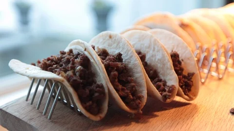 Close up of soft beef tacos on rack 스톡 동영상 107945001