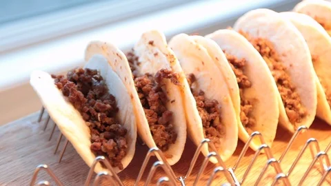 Close up of soft beef tacos on rack left to right 스톡 동영상 107945015
