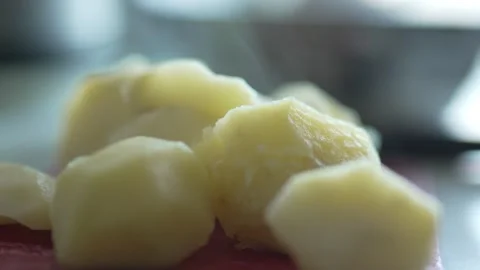 Close-up of soft boiled potato chunks with light rising steam Stock Footage 333633898