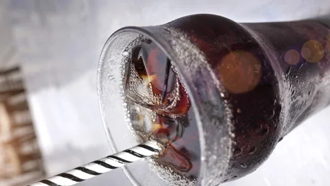Close up of a soft drink with ice cubes and a straw Stock Footage 165198173